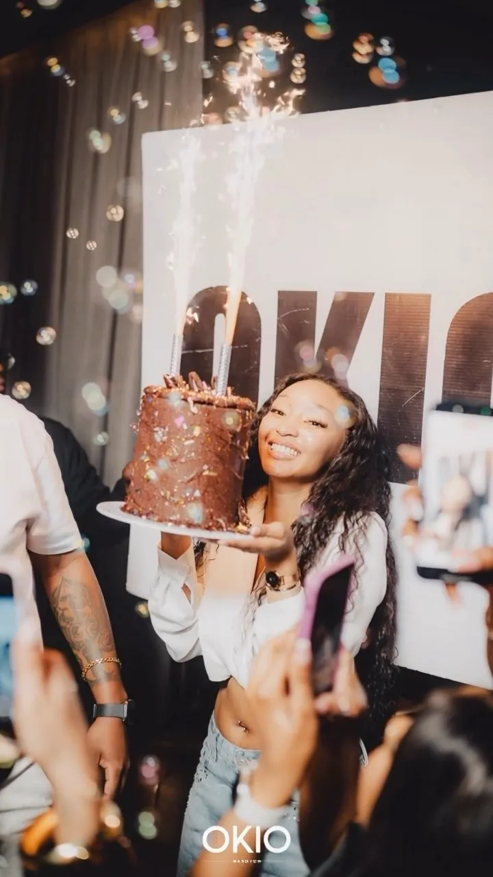 A birthday cake with sparklers carried through OKIO