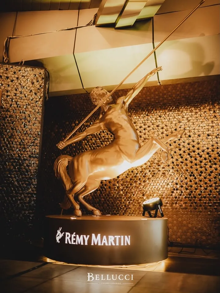 The Remy Martin centaur on a marble-top table at Bellucci